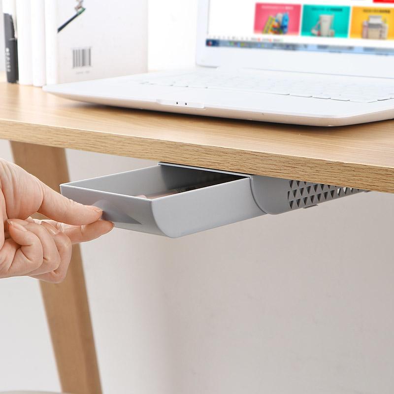 under-desk pen holder drawer below a desk