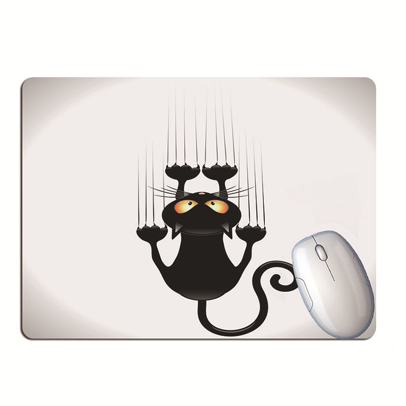 black cat desk mat for keyboard and mouse used in a home office workspace