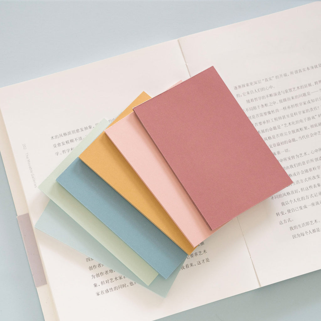 warm color sticky memo notes for desk planning used in a home office workspace