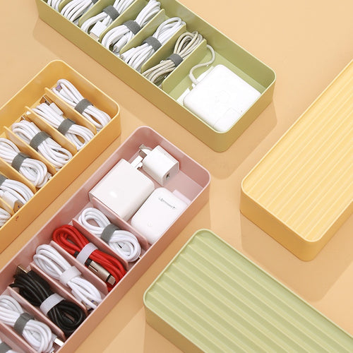 close up of clear covered cable storage box for chargers for small desk organization