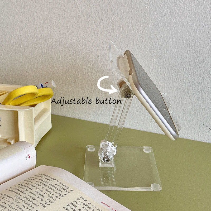 clear acrylic phone and tablet stand used in a home office workspace