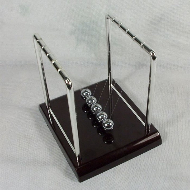 newton ball desk toy for stress relief on a clean desk setup