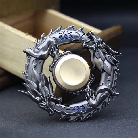 metal spinning top desk fidget toy used in a home office workspace
