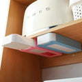 stick-on under-desk pen drawer on a clean desk setup
