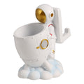 astronaut pen holder on a small desk