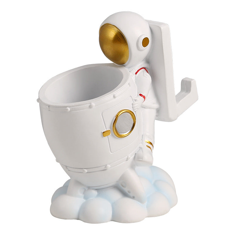 astronaut pen holder on a small desk