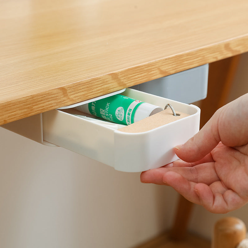 stick-on under-desk pen drawer keeping a workspace organized