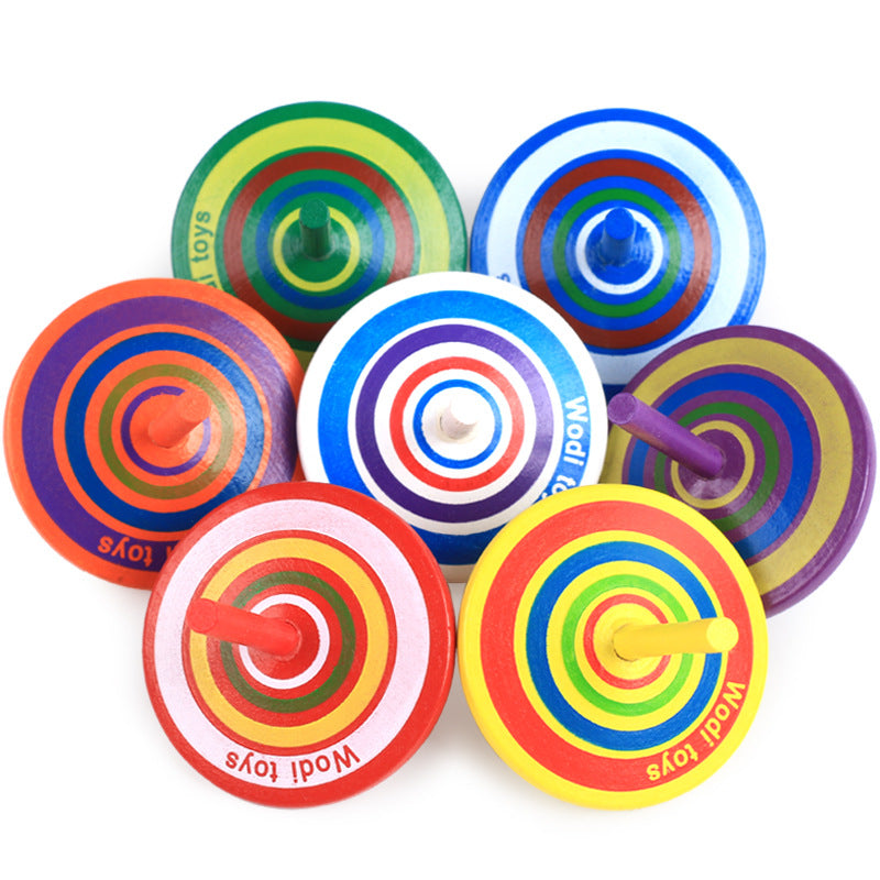 wooden spinning top stress relief desk toy on a clean desk setup