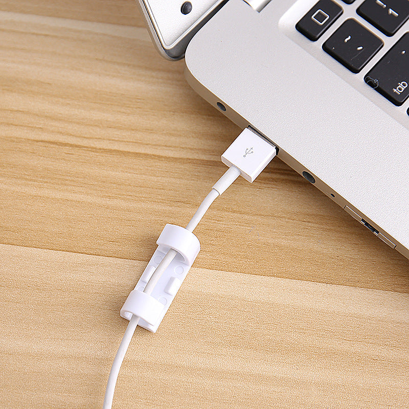 self-adhesive cable clips organizing cords on a desk