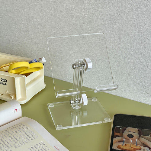 close up of clear acrylic phone and tablet stand for small desk organization