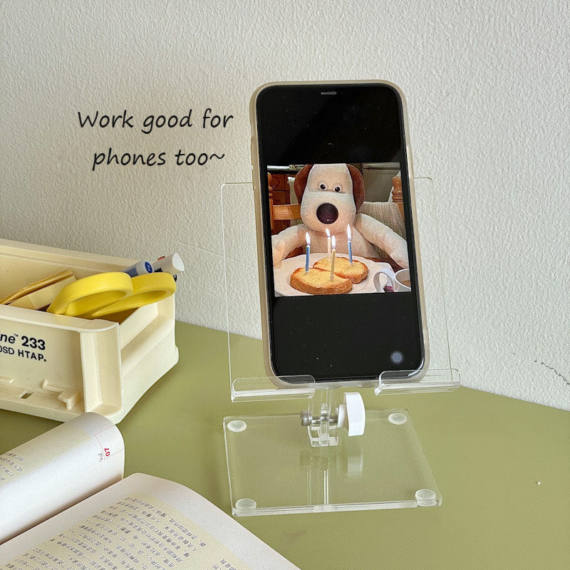 clear acrylic phone and tablet stand keeping a workspace organized