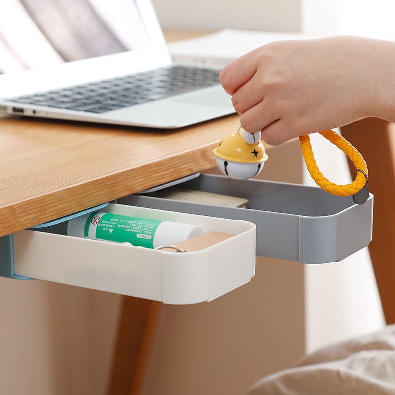 close up of stick-on under-desk pen drawer for small desk organization