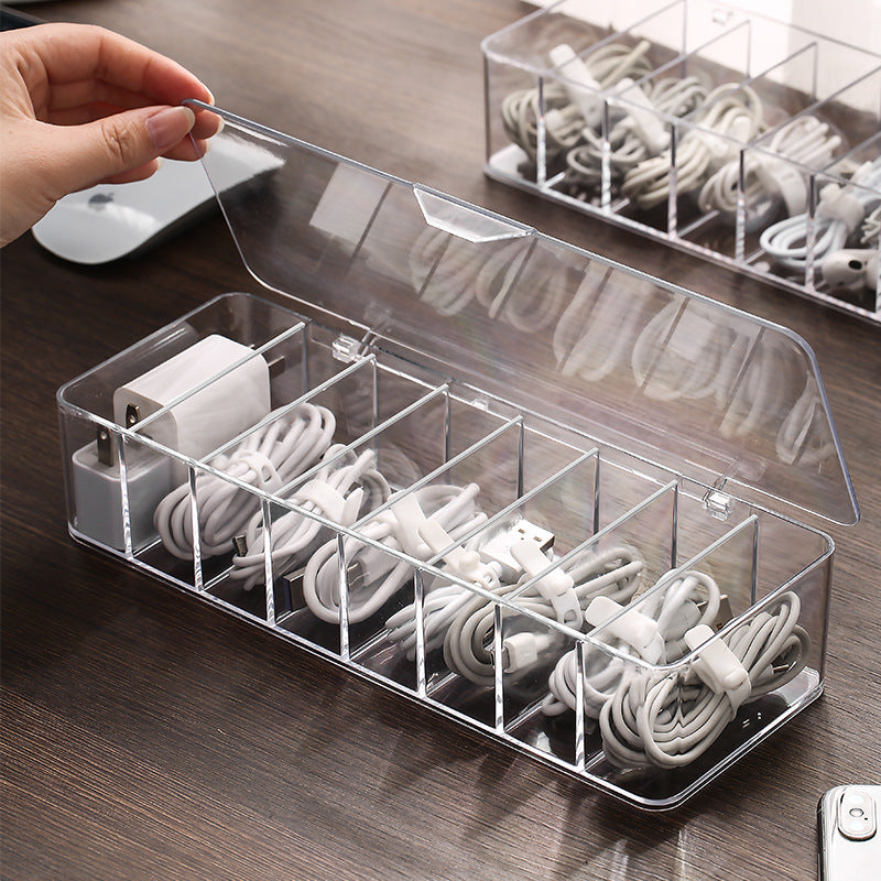 transparent cable storage box on a desk