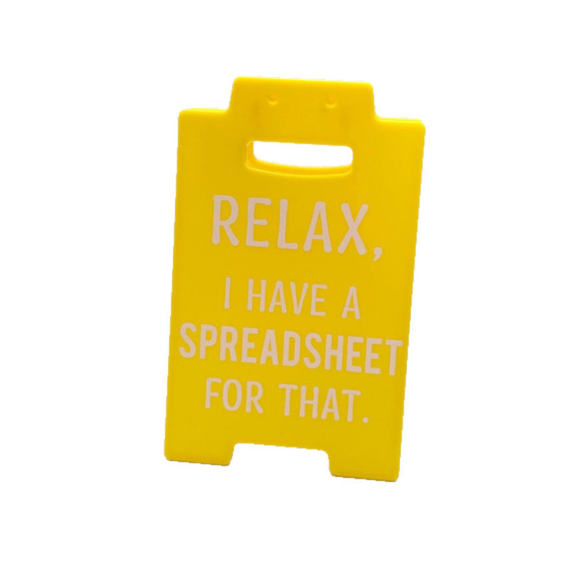 funny desk decor sign for work setups used in a home office workspace
