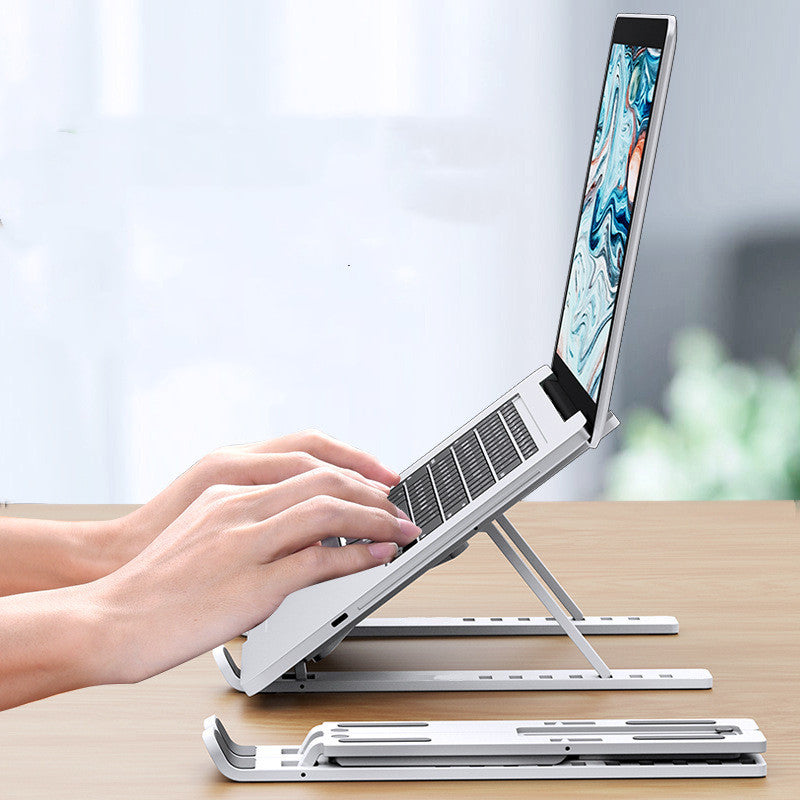portable laptop riser stand with cooling vents keeping a workspace organized